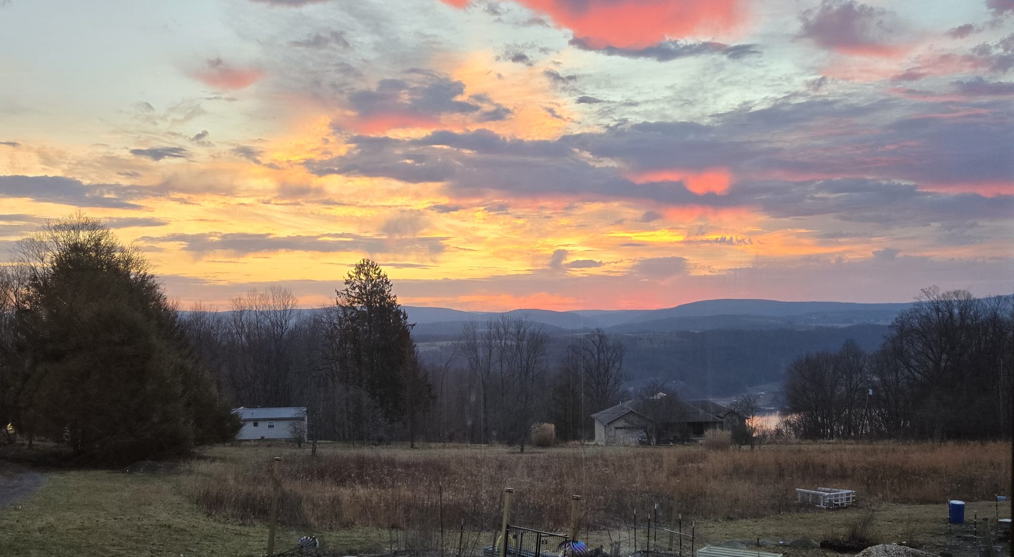 Sunrise over the Youghiogheny valley from the farm, with the garden beds and meadow in the foreground